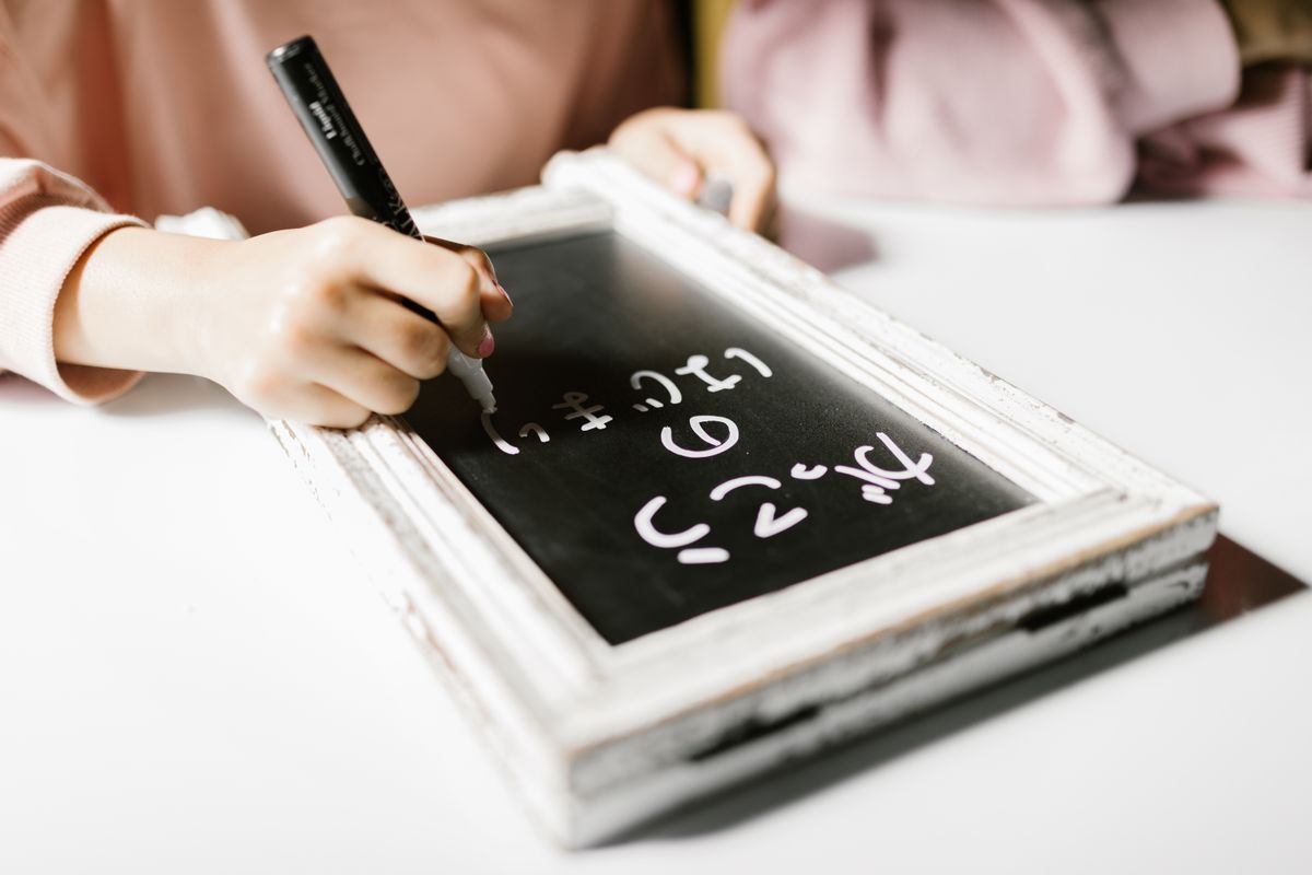 Writing hiragana by hand on a small chalkboard